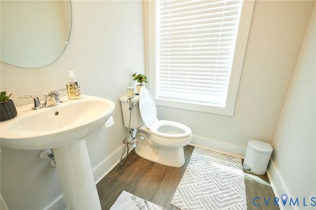 Half bathroom featuring toilet and wood finished floors | Image 28