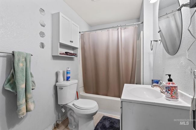 Bathroom with vanity, shower / tub combo, and tile patterned floors | Image 14
