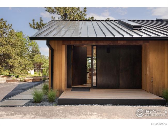 Black metal accents and Class 4 impact and fire-resistant metal roof with seamless box gutters | Image 4
