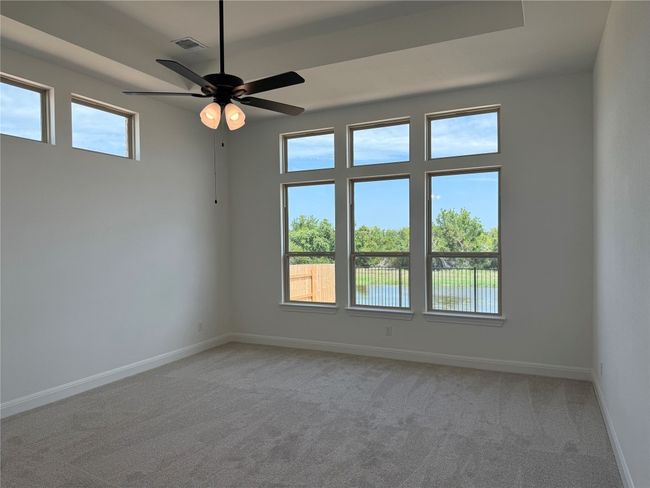 Unfurnished room with light carpet and ceiling fan | Image 4
