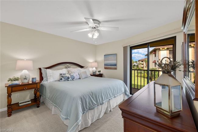 Carpeted bedroom with ceiling fan and access to outside | Image 12