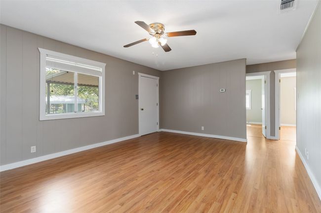 Unfurnished room with baseboards, a ceiling fan, visible vents, and light wood-type flooring | Image 10
