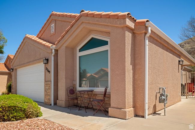 Exterior space with stucco siding, an attached garage, and a tile roof | Image 4