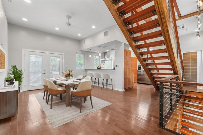 Dining space featuring stairway, wood finished floors, french doors, and recessed lighting | Image 7