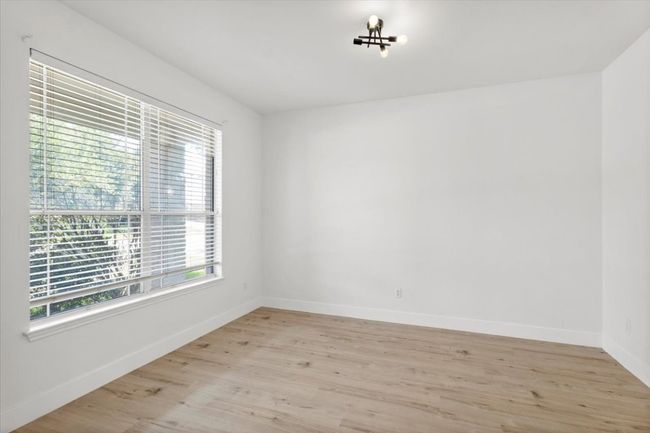 Unfurnished room featuring light wood-type flooring and baseboards | Image 13