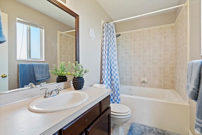 Full bath featuring vanity, toilet, and shower / bath combo | Image 16