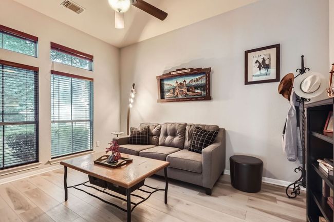 Living room with light wood finished floors and a ceiling fan | Image 10