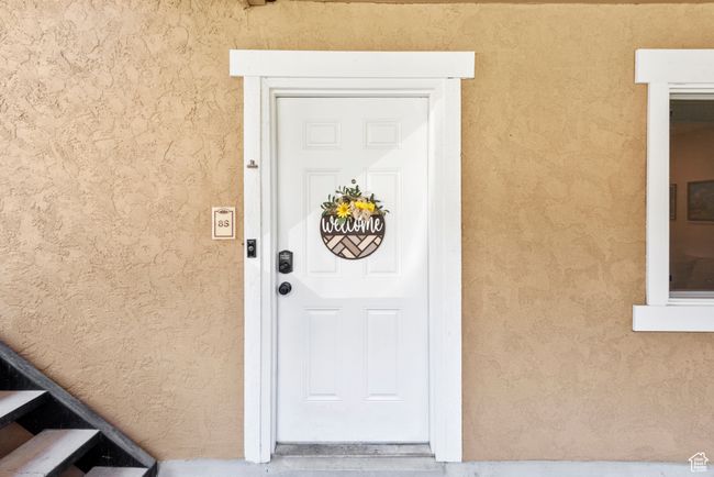 Entrance to property with stucco siding | Image 8