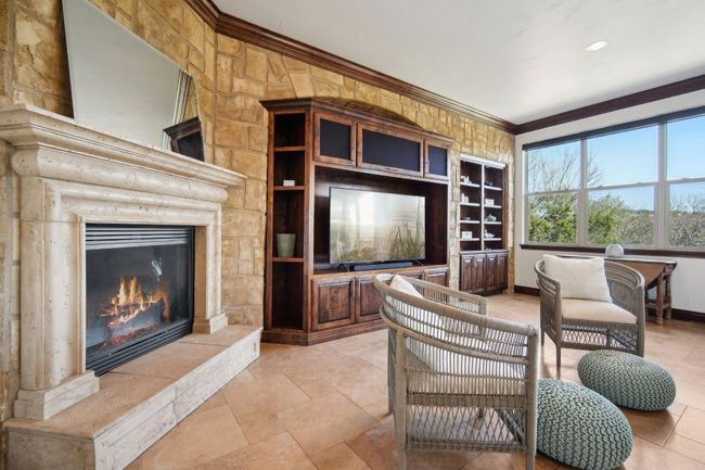 Living room featuring a tiled fireplace, baseboards, and ornamental molding | Image 11