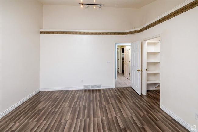 Primary bedroom with dark wood-type flooring | Image 19