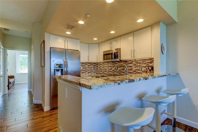 Kitchen with Stone Countertops, Stainless Steel Applicances | Image 18