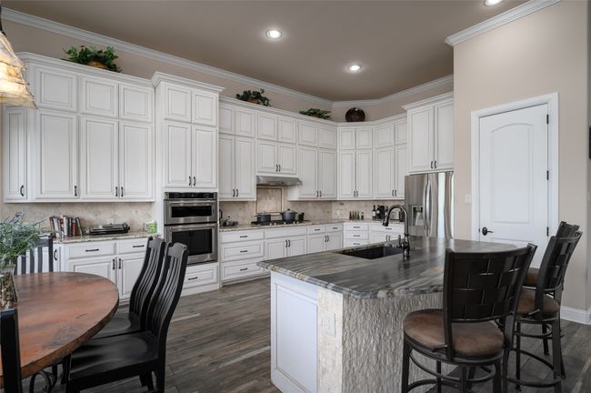 Kitchen with island. Note the pantry entrance. | Image 11