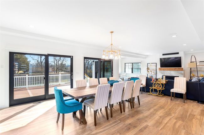 Dining area with recessed lighting, light wood-type flooring, a fireplace, and a notable chandelier | Image 6