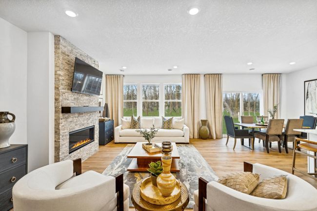 Photo is of the actual model. The great room offers large windows for natural light. | Image 6