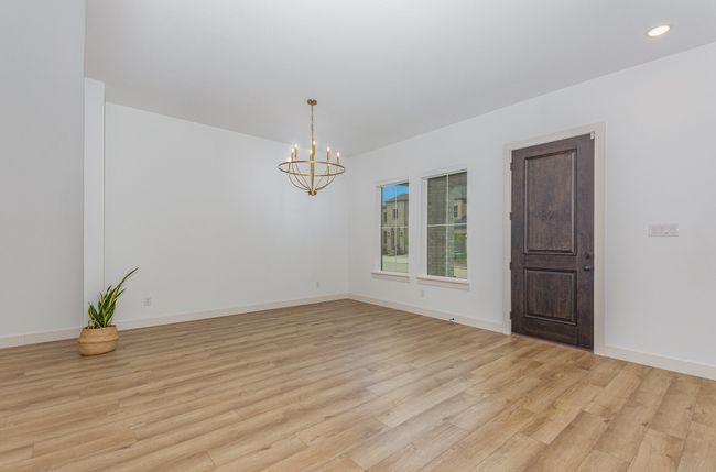 Spare room with a chandelier, light wood-type flooring, and recessed lighting | Image 10