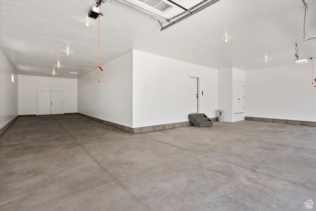 Garage with a garage door opener and baseboards | Image 18