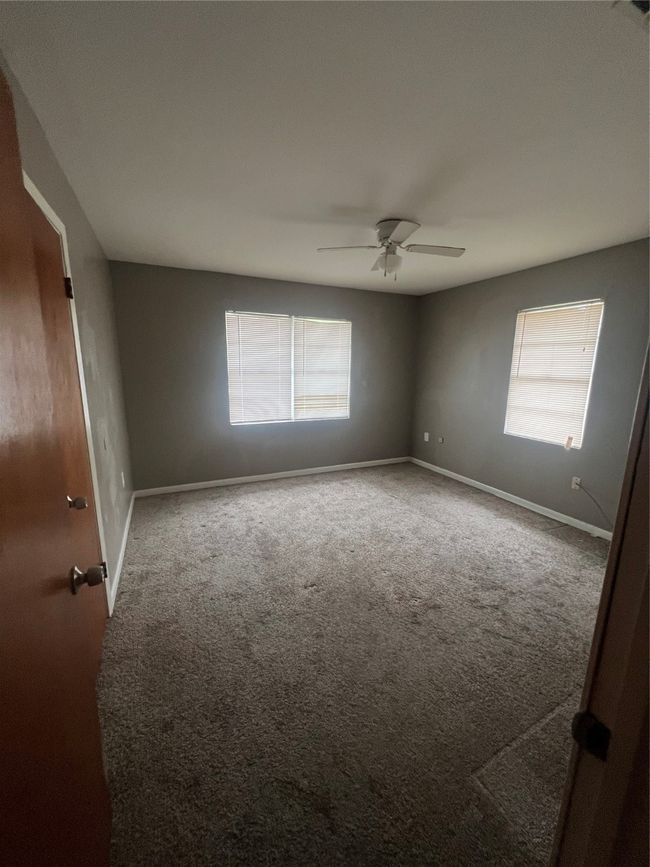 Empty room with carpet, baseboards, and a ceiling fan | Image 7