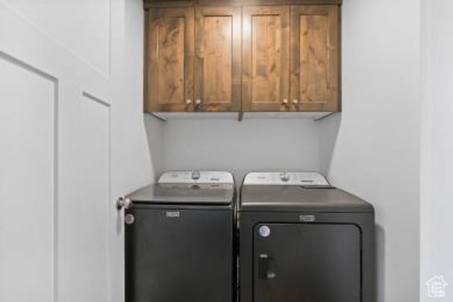 Clothes washing area with cabinet space and washer and clothes dryer | Image 14