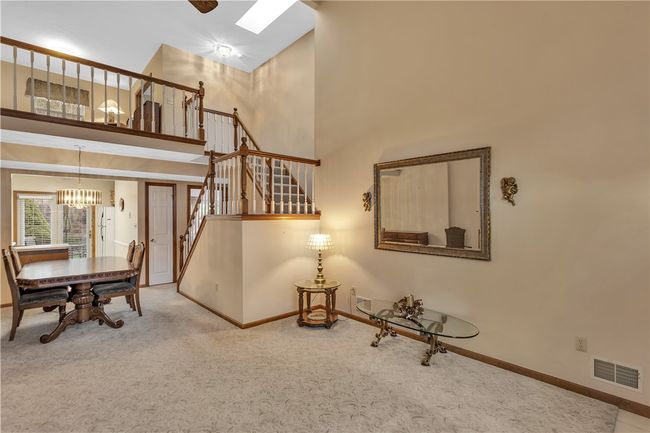 Beautiful Open Railing with Contrast Wood Posts Leading to the Loft/Den and Upper Level Bedroom. | Image 6