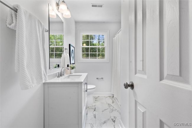 updated full bath on second floor - new flooring, vanity, commode, and tub/shower combination with tile surround | Image 15