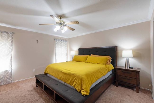 Bedroom featuring ornamental molding, light colored carpet, and ceiling fan | Image 17