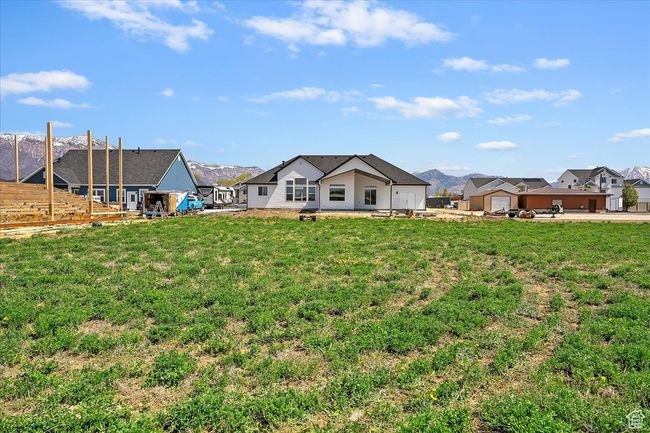 Back of property with a residential view, a lawn, and a mountain view | Image 21