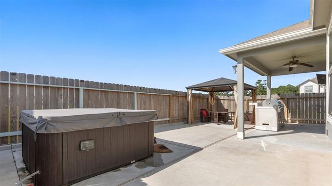 Back covered patio with fan, stainless steel BBQ Grill and mini fridge (Jacuzzi & TV also included in sale) | Image 15
