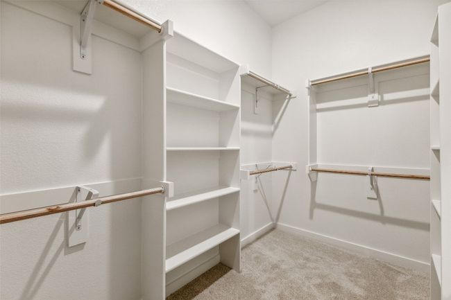 Spacious closet featuring light carpet | Image 14