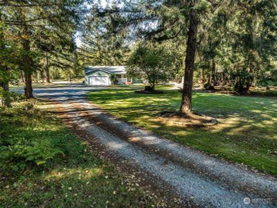 Tucked at the end of a gravel drive, is the sweeping private driveway up to your front door. | Image 2