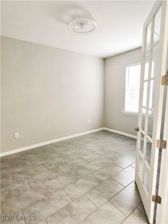 Empty room featuring baseboards, french doors, and light tile patterned flooring | Image 5