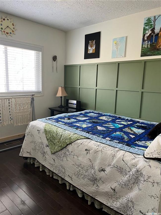 Bedroom with hardwood / wood-style floors and a textured ceiling | Image 35