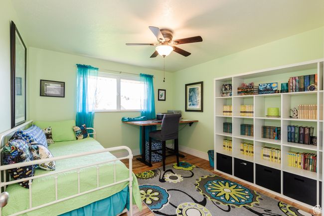 Bedroom featuring wood finished floors, baseboards, and ceiling fan | Image 17