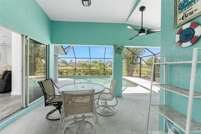 Covered lanai overlooks the caged pool | Image 36