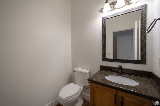 Half bathroom with toilet, vanity, and baseboards | Image 13
