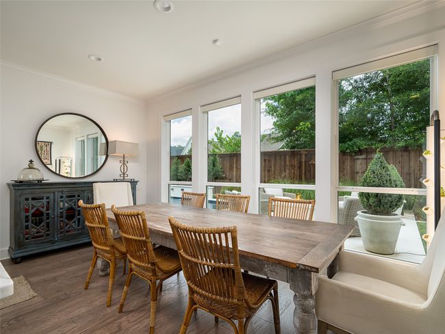 Dining area with wood finished floors, ornamental molding, and recessed lighting | Image 10