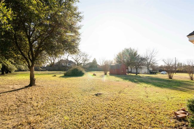View of green lawn featuring an outdoor structure | Image 26