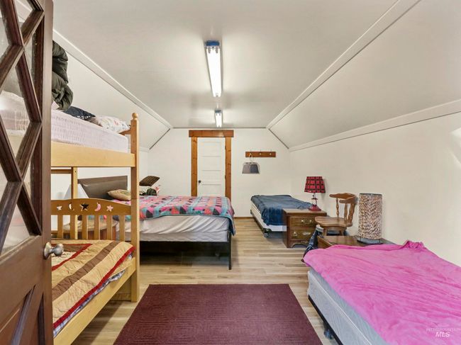 Bedroom featuring lofted ceiling and wood finished floors | Image 43