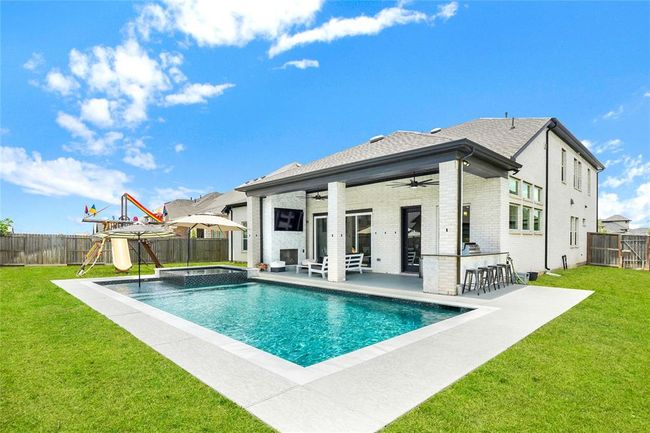 Backyard oasis equipped with full outdoor amenities including playground | Image 4