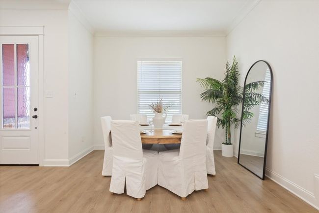 Dining area with light wood finished floors, healthy amount of natural light, and ornamental molding | Image 6