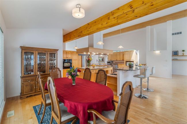Dining room with light wood-style flooring, high vaulted ceiling, and beam ceiling | Image 14
