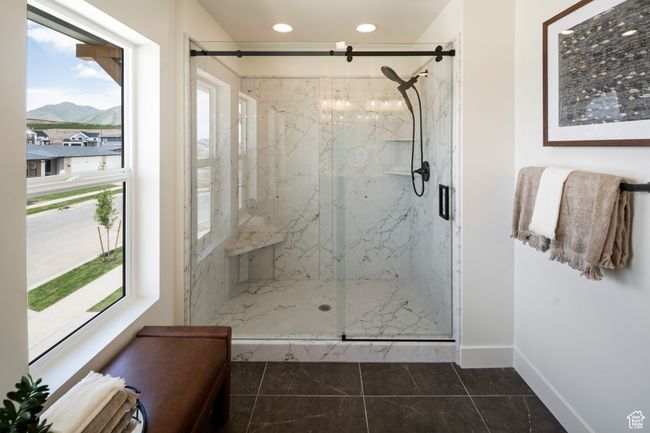 Full bathroom featuring plenty of natural light, a mountain view, a marble finish shower, baseboards, and recessed lighting | Image 20
