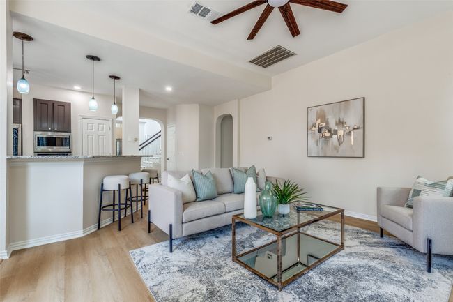 Living area with arched walkways, ceiling fan, light wood-style flooring, baseboards, and recessed lighting | Image 5