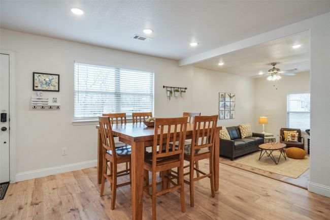 Dining room with ceiling fan and light wood-type flooring | Image 10