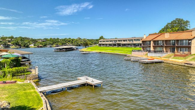 Dock area featuring a balcony and a water view | Image 28