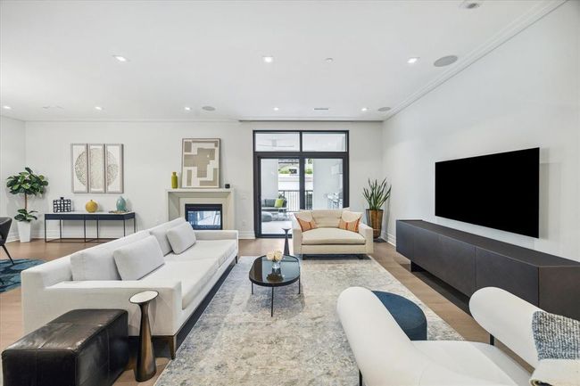 [Living area open to Terrace] Alternate view of the capacious living room, with sleek focal point gas fire place | Image 16