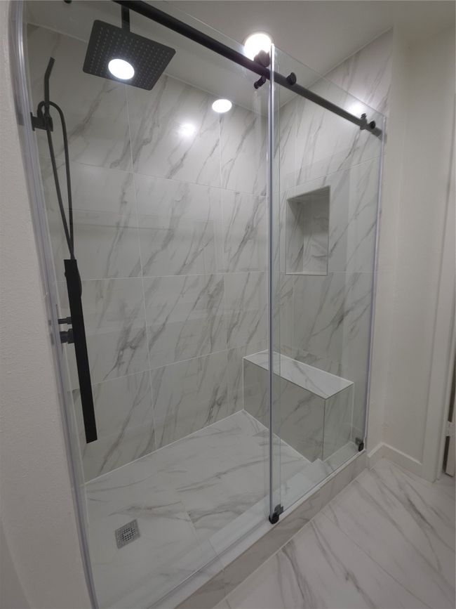 Bathroom with a marble finish shower and marble finish floors | Image 15