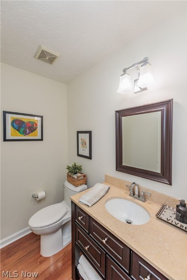 Bathroom featuring hardwood / wood-style flooring, toilet, and vanity | Image 21