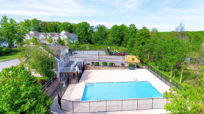 Community pool with fence, a patio, and stairway | Image 33