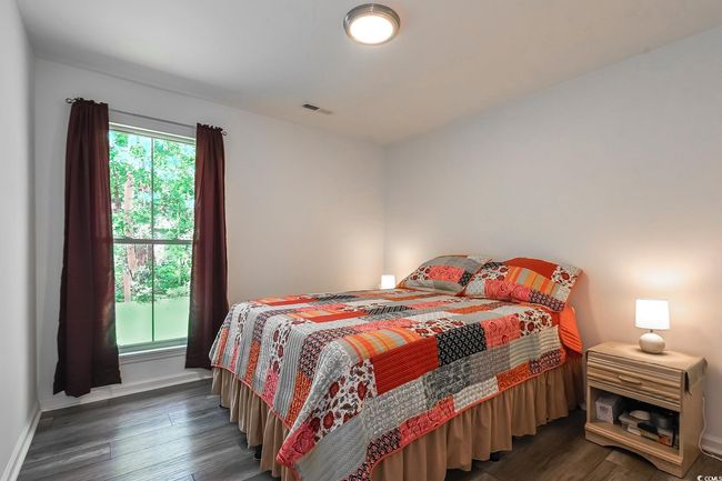 Bedroom with dark wood-style flooring and baseboards | Image 10