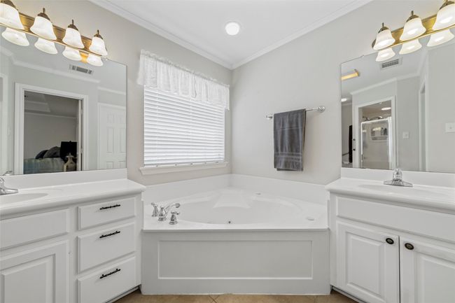 Full bath featuring two vanities, a bath, visible vents, and a sink | Image 19